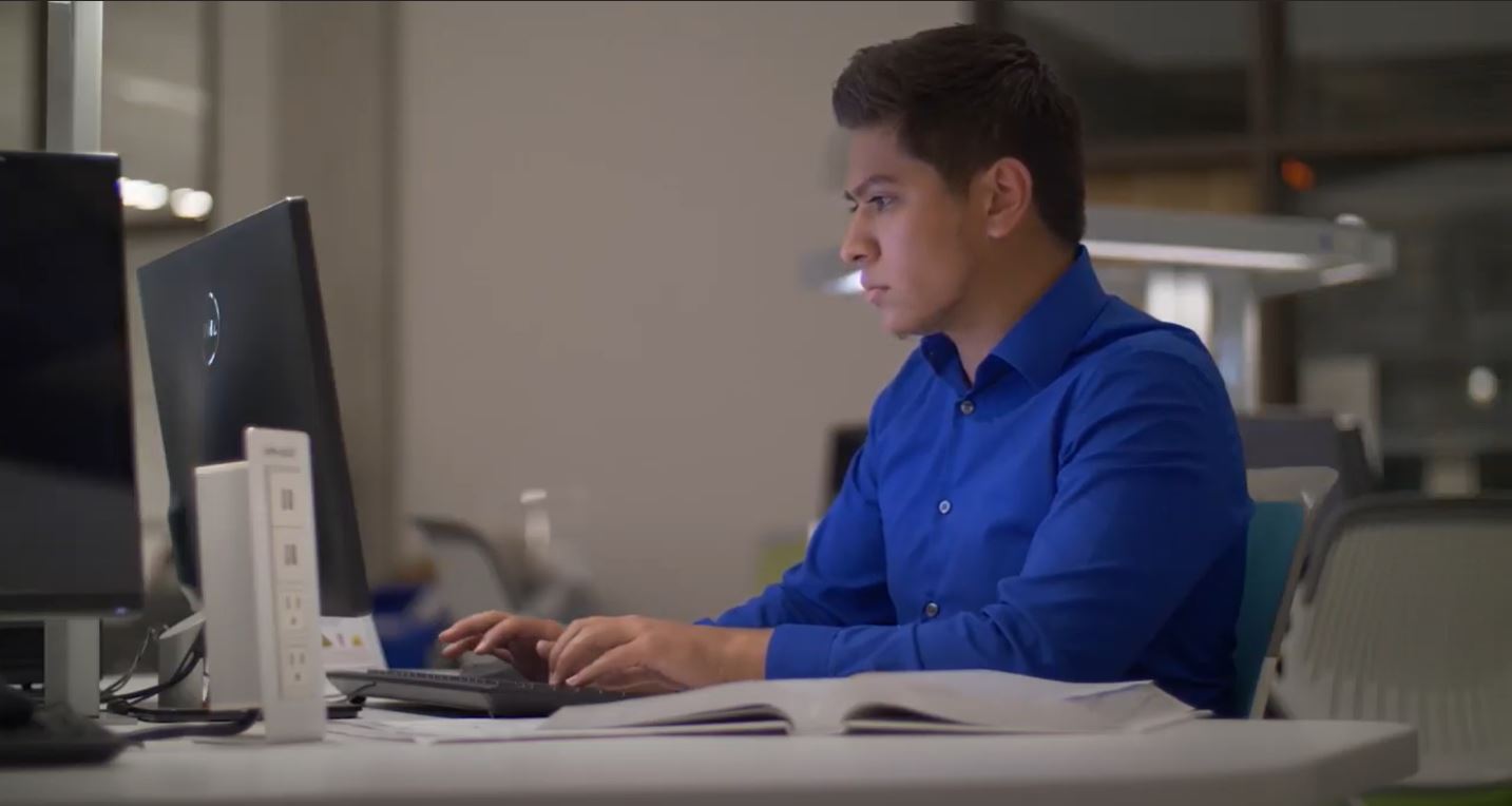 Graduate Jason Lopez studies at a computer in a computer lab.